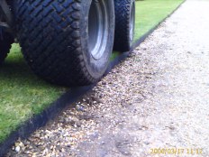 Tractor wheel on lawn edged with Smartedge
